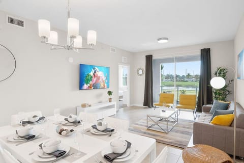 Modern open concept of living room, dining room and kitchen with island!LAKE VIEW & 65" Smart TV!#Disney #Parks #kingdom #springs #StoreyLake #Apartment #Vacation #Rental #waterpark #Kissimmee #Orlando #universal #citywalk