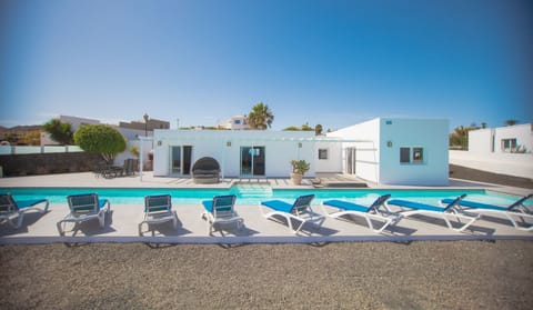 Relax on sunbeds by the pool under the warm Lanzarote sun