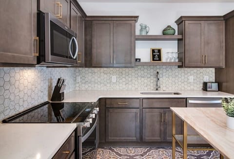 Whip up culinary delights in our sleek and modern kitchen, where every meal becomes a masterpiece.