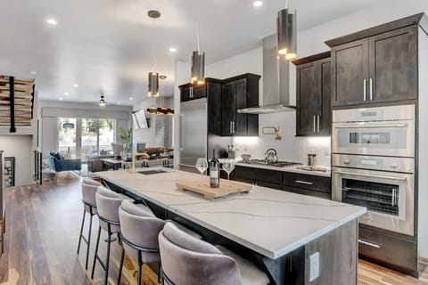 Island Area With Bar Sink, Wine Fridge, And Bar Seating For 4 People