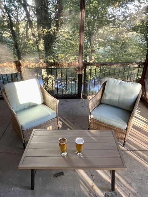 Covered back porch overlooks the river!