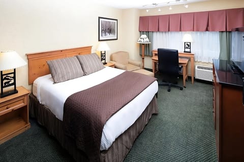Recharge in a calm king room with dedicated workspace.