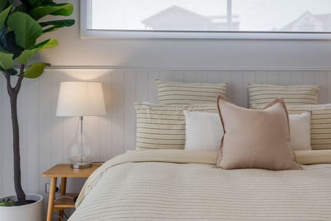 This tranquil bedroom boasts a soft pastel color scheme, creating a serene and calming atmosphere that invites relaxation and rejuvenation.