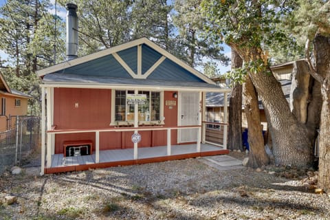 Welcoming cabin entry surrounded by towering pine trees, offering fresh mountain air and a peaceful forest setting—the perfect first impression for your Big Bear Lake getaway.