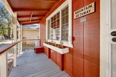 Welcoming cabin entry surrounded by towering pine trees, offering fresh mountain air and a peaceful forest setting—the perfect first impression for your Big Bear Lake getaway.