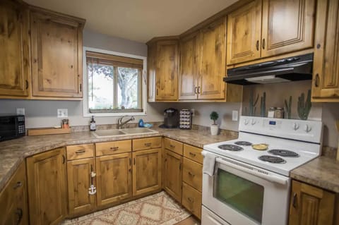 Kitchen fully stocked with seasons and cooking utensils.