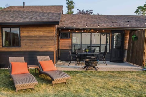 Outside living space. Fire pit with table and chairs and lounge chairs. 