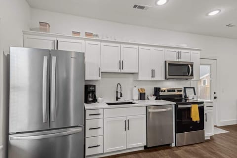 Prepare meals in the fully equipped kitchen with sleek cabinets, stainless appliances and ample counters.