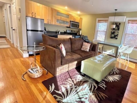 Living room with dining area, fireplace, and full kitchen (3)