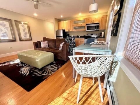 Living room with dining area, fireplace, and full kitchen (1)