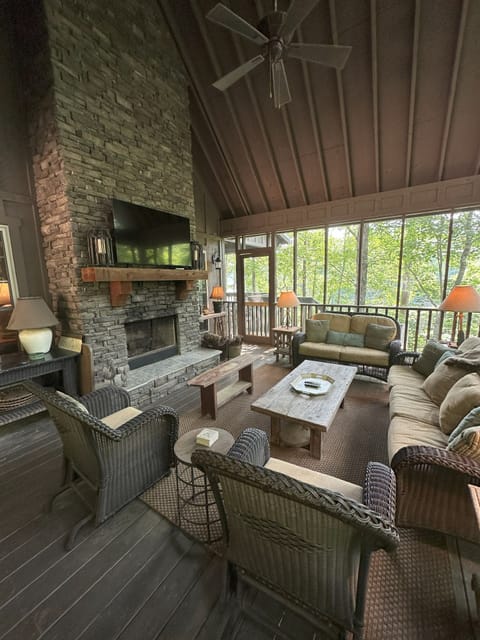 Expansive screened porch, with wood-burning fireplace, overlooks the lake.