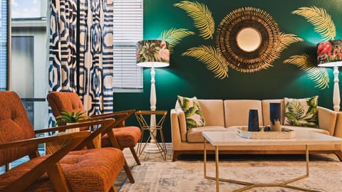 Tropical oasis with chic decor, vibrant accents, and cozy seating in every corner.