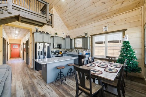 Gather in this open-concept cabin kitchen where rustic wood meets modern comfort—your perfect space for cooking and sharing meals together.