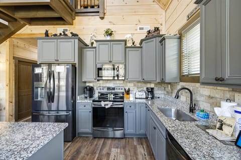 Your fully equipped kitchen features granite countertops, stainless steel appliances, and charming cabin touches for memorable meal prep.