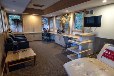 Upper level office/lounge area looking out at the treetops