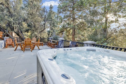 Private outdoor hot tub, surrounded by tall pines, perfect for relaxing under the trees after a day of adventure—enjoy peaceful forest views, fresh air, and a truly rejuvenating stay.