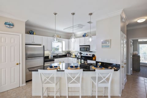 Kitchen offers a bar area with seating for 3 additional people.