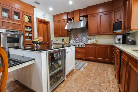 Kitchen with sub-zero fridge, full freezer, 2 sinks, dishwasher and gas cooktop