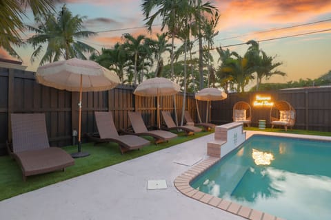 Have a sunset relaxation w/ the large pool w/ waterfall, loungers, trees & more.