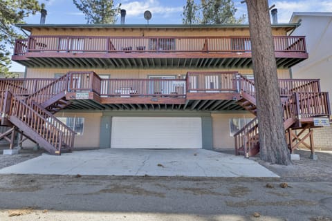 Welcoming cabin entry surrounded by towering pine trees, offering fresh mountain air and a peaceful forest setting—the perfect first impression for your Big Bear Lake getaway.