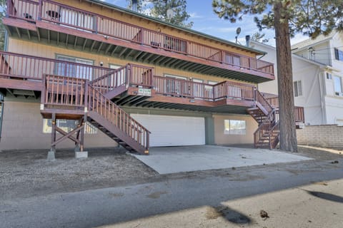 Welcoming cabin entry surrounded by towering pine trees, offering fresh mountain air and a peaceful forest setting—the perfect first impression for your Big Bear Lake getaway.