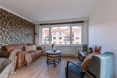 Warm living room with textured accent wall and soft natural light.
