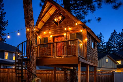 Whimsical backyard treehouse glowing at dusk ~ a cozy space where imagination, family fun, and unforgettable memories come to life.