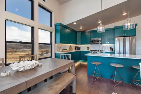 Mayflower Lakeside 1121-304: Next to the kitchen, you'll find a wooden dining table paired with modern chairs.