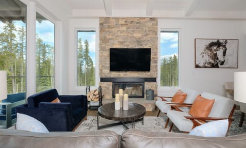 Main floor living room with wood burning fireplace (wood provided), Smart TV