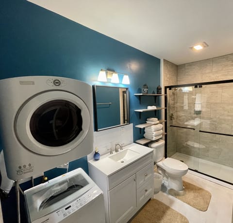 Full bathroom with small washer and dryer
