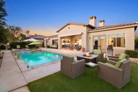 Resort-style backyard oasis with pool, fire pit, sunset views