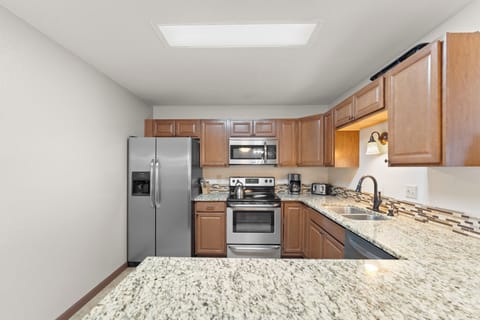 Full kitchen featuring all stainless steel appliances.