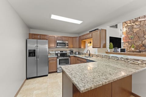 Full kitchen featuring all stainless steel appliances.