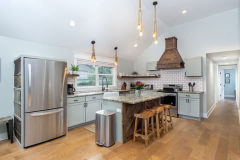 Kitchen complete with island with seating for 3, a dishwasher & a standard Drip coffeemaker.