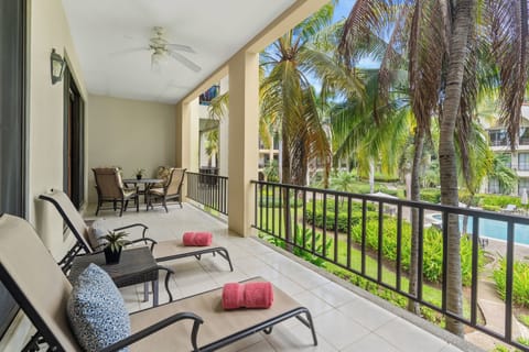 The condo's large terrace is flanked by palms and set back from the pool.  Enjoy sunshine in the morning and shade in the afternoon!
