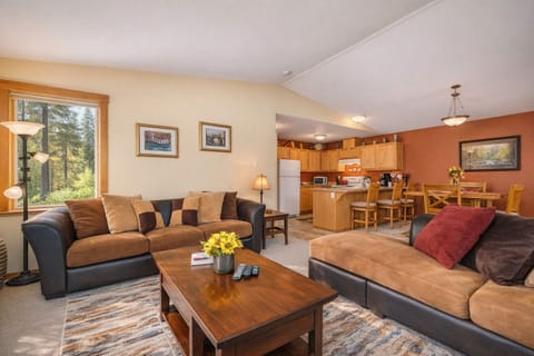 Unwind in your spacious living room with plush sofas and a fully equipped kitchen, perfect for memorable meals together.
