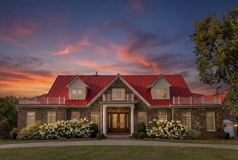 Stunning exterior at sunset showcasing the iconic red roof and grand entrance.