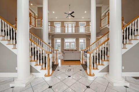 Grand double staircase with marble entryway