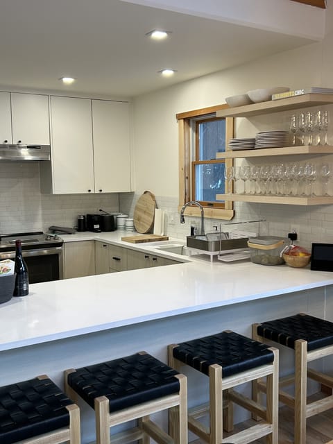 Kitchen with counter for breakfast or apres ski. custom stools