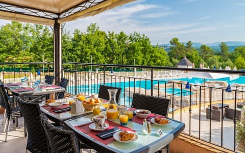 Enjoy dining outdoors on the patio overlooking the pool.