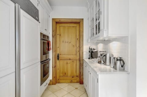 Cozy kitchen and coffee nook with modern appliances and rustic wooden details for a charming cooking space.