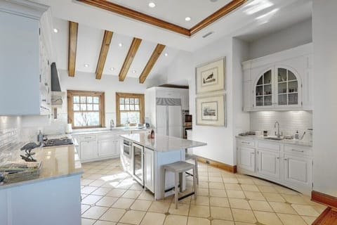 Bright and airy kitchen with ample natural light, offering a welcoming space for meal preparation.