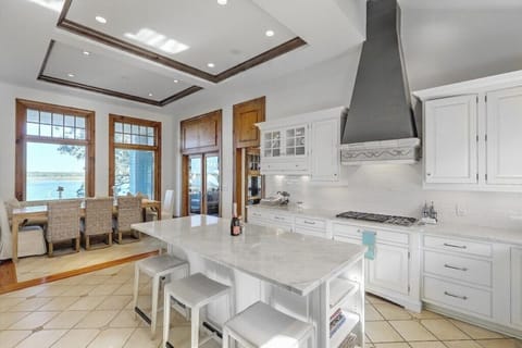 Modern kitchen featuring marble countertops and a spacious island, ideal for cooking and entertaining.