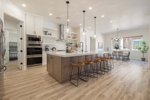 Large, modern kitchen provides an ideal gathering space and has all of the appliances, utensils, and storage for cooking.
