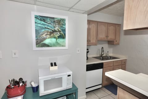 Fully equipped kitchen, dining area and bar seating — ideal for home-cooked meals after a day at the beach.