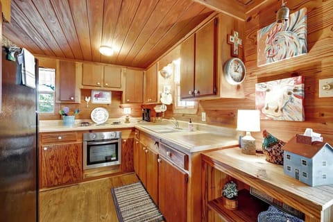 Kitchen equipped with a stove, refrigerator, microwave, coffee maker and plenty of counter space 