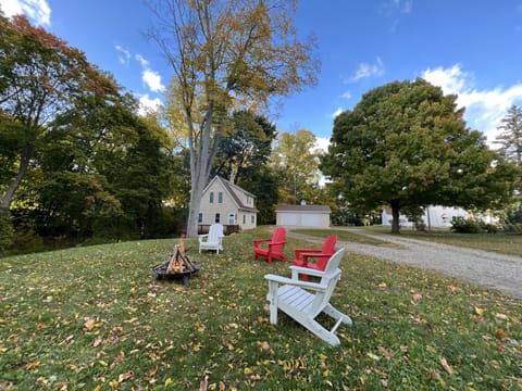 Front yard with plenty of parking, fire pit, and chairs