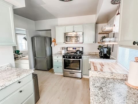 New cabinets, countertops, and appliances including gas stove with all essential cooking utensils to accommodate eating in!