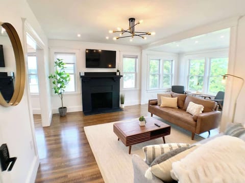 Living room: Bright and spacious. TV with Netflix, Hulu, Disney, Prime. Soft lights with many windows. 