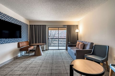 Stretch out in the airy suite with balcony doors glowing.
